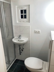 Bad mit Dusche 80 x80 cm, WC und Waschbecken.